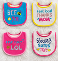 Four colorful baby bibs new with tags on a white rug