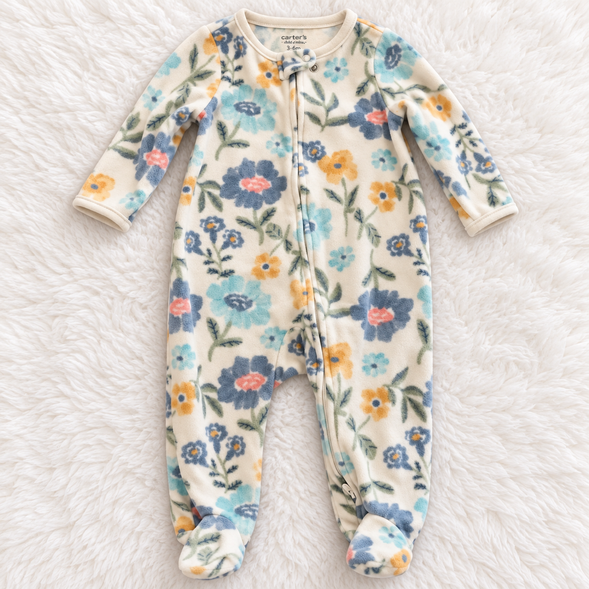 Carter's Child of Mine floral fleece footed sleeper, size 3-6 months, on white rug
