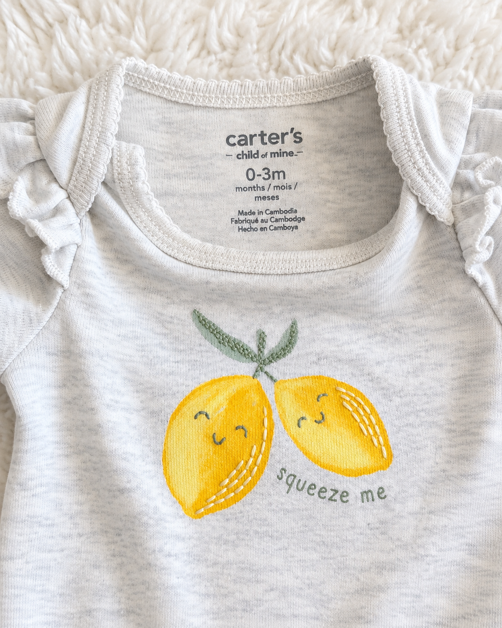 Carter’s Child of Mine 0–3 month lemon bodysuit detail