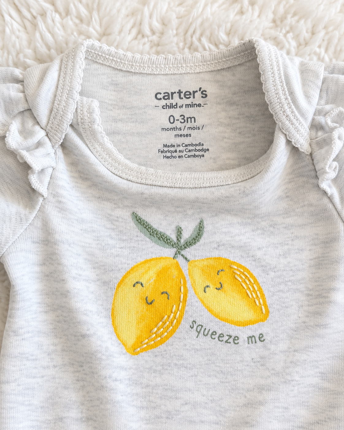 Carter’s Child of Mine 0–3 month lemon bodysuit detail
