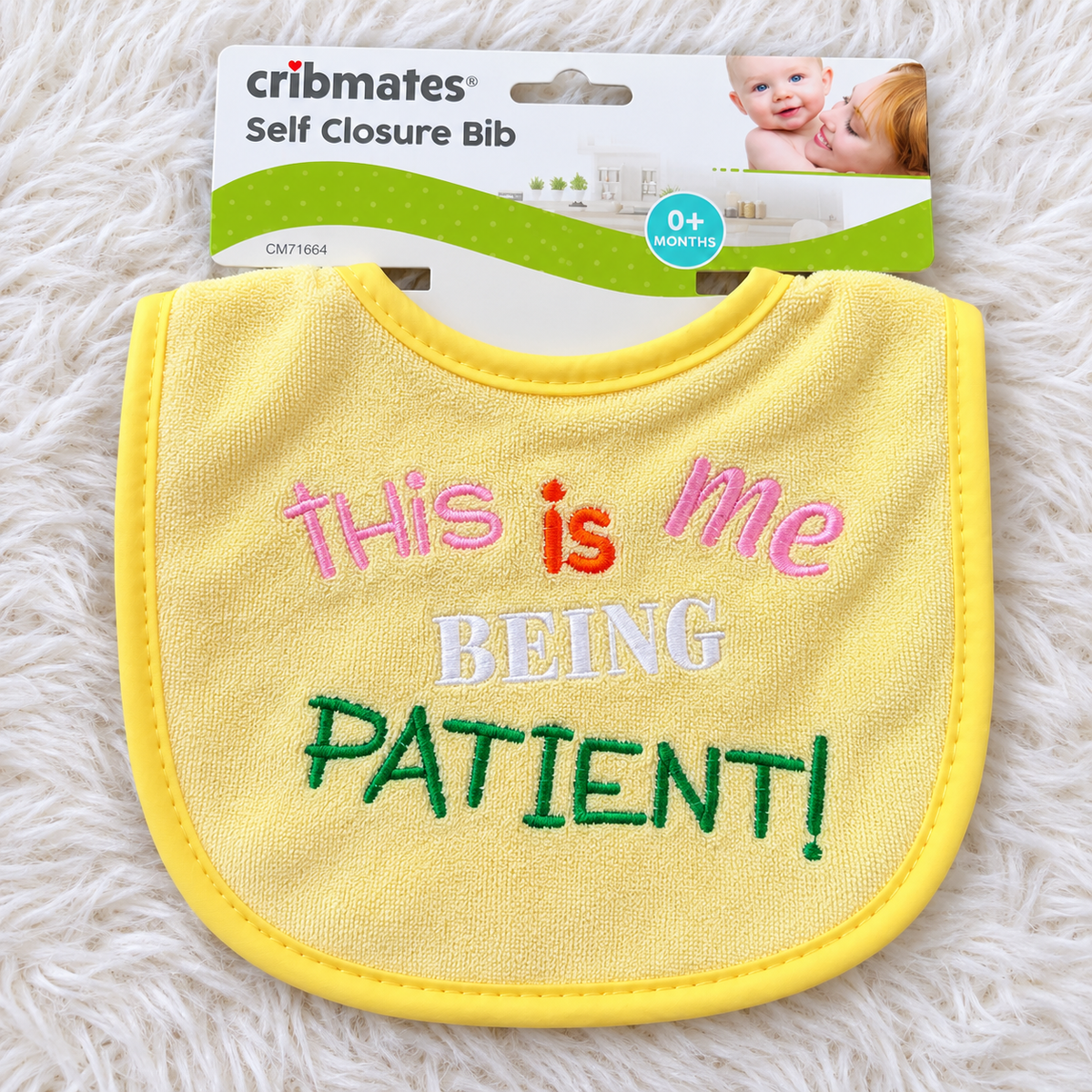 Cribmates This Is Me Being Patient baby bib on white rug