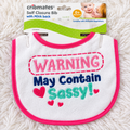 Cribmates Warning May Contain Sassy baby bib on white rug