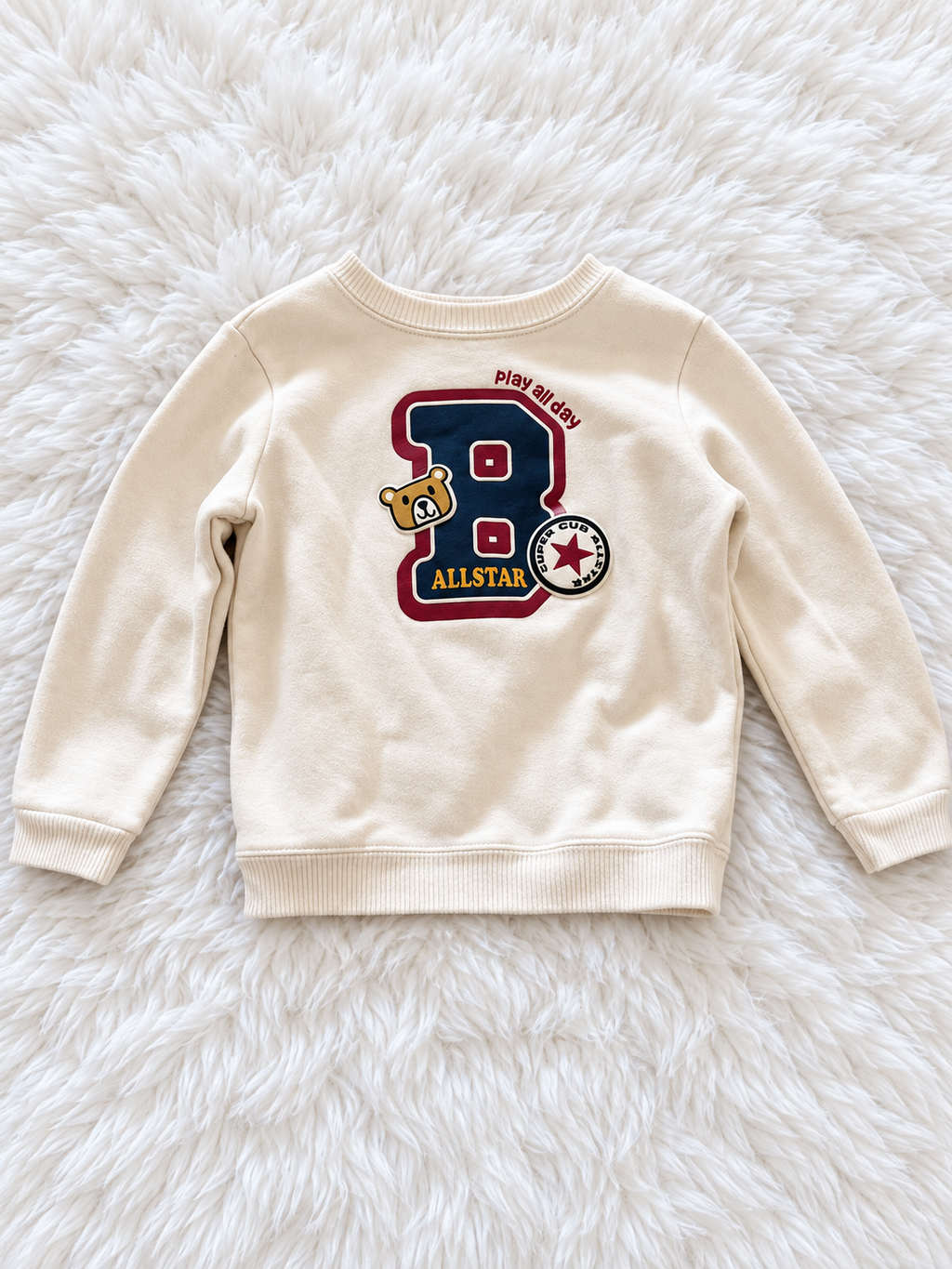 Cream Garanimals Allstar sweatshirt on white rug