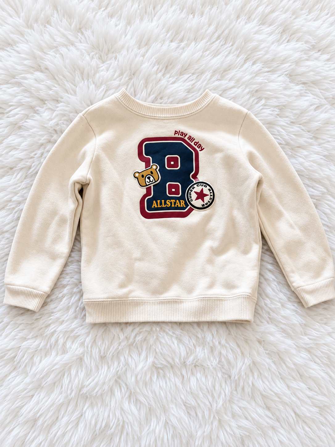 Cream Garanimals Allstar sweatshirt on white rug