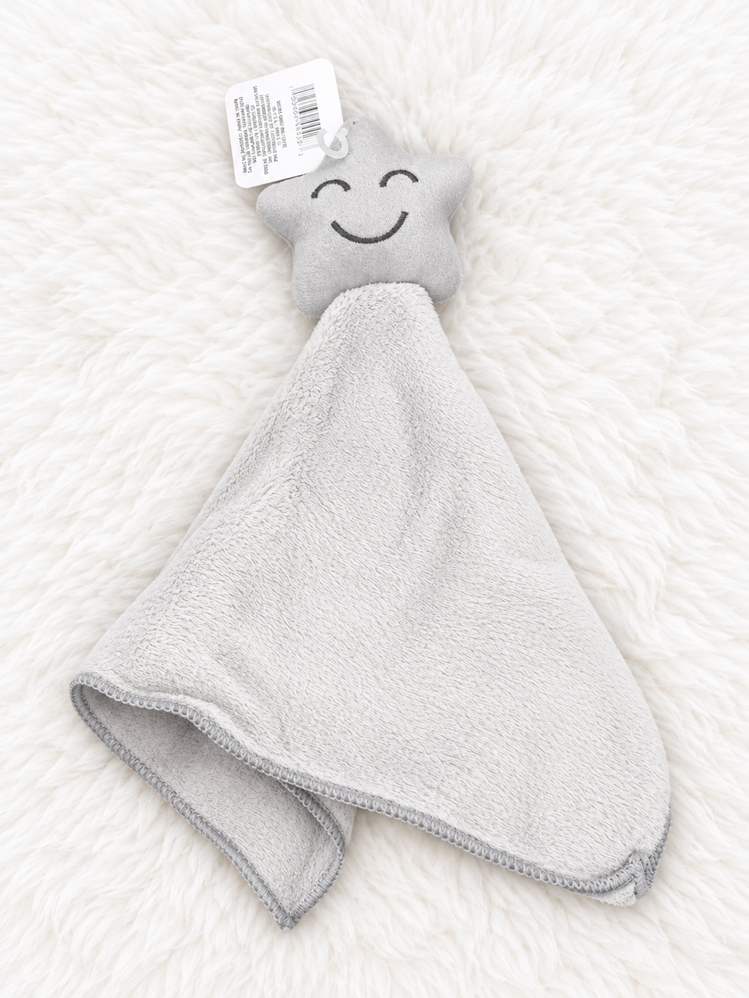Gray star baby lovey security blanket on white rug