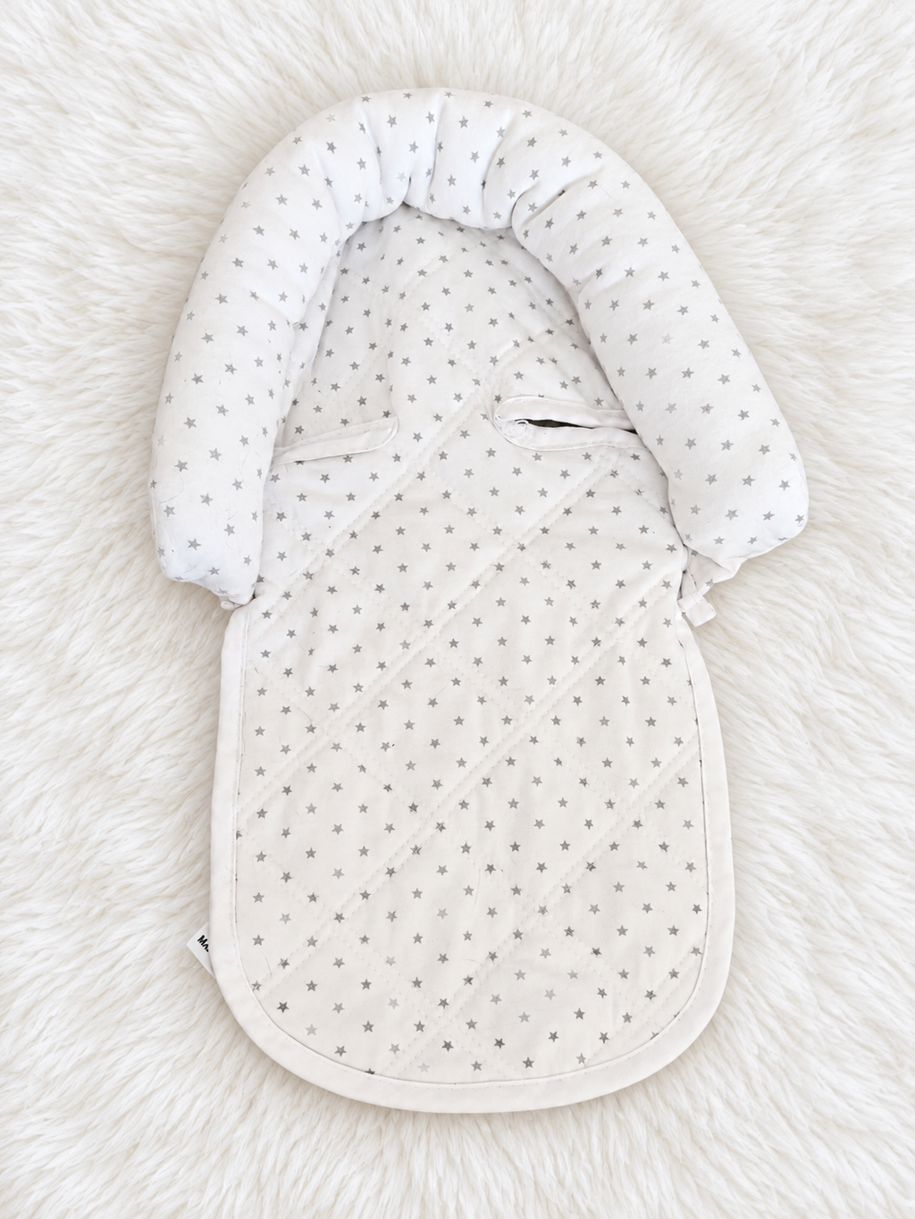 White and gray star infant support insert front on white rug