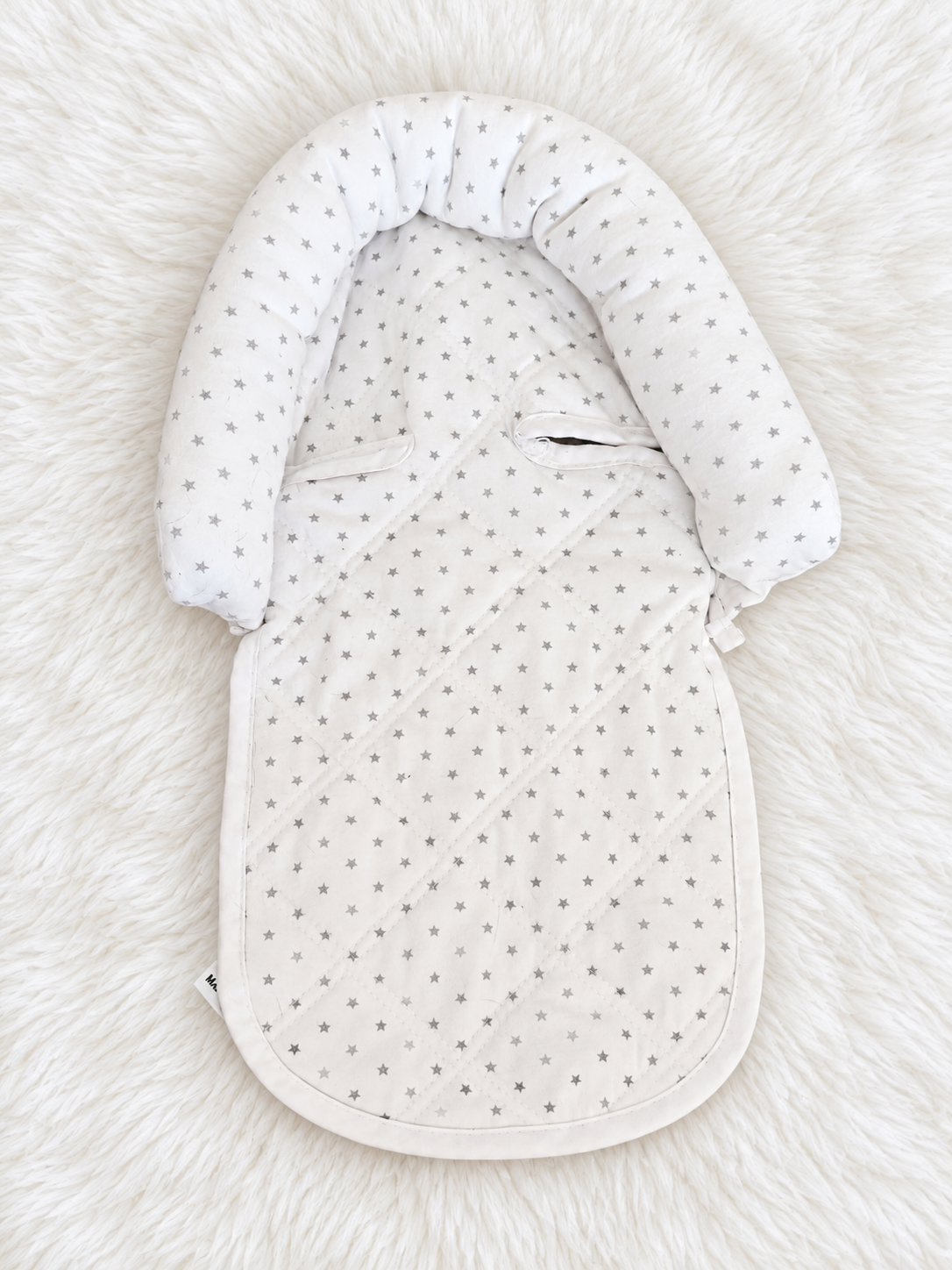 White and gray star infant support insert front on white rug