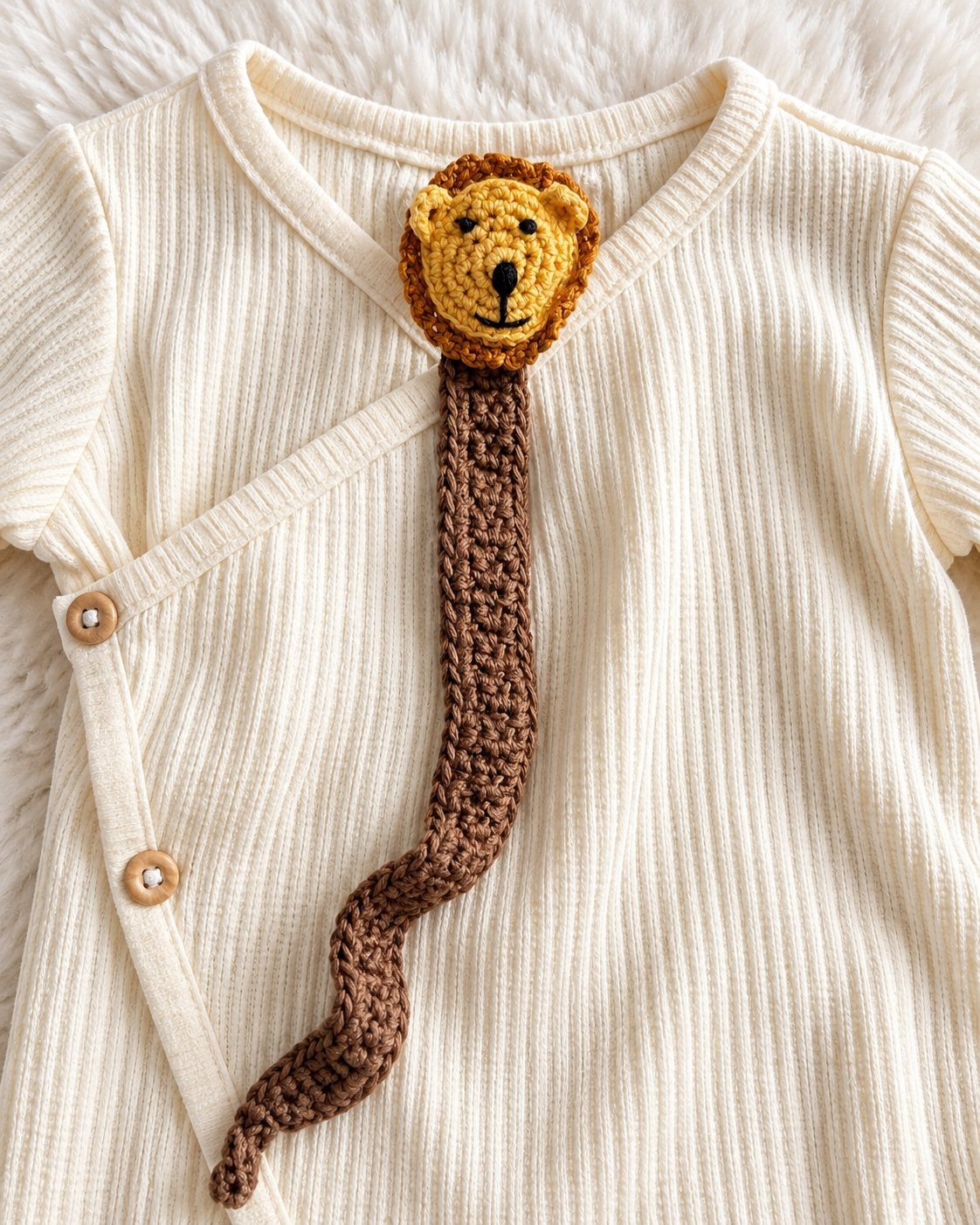 Close-up of lion crochet detail on Grayson Collective romper