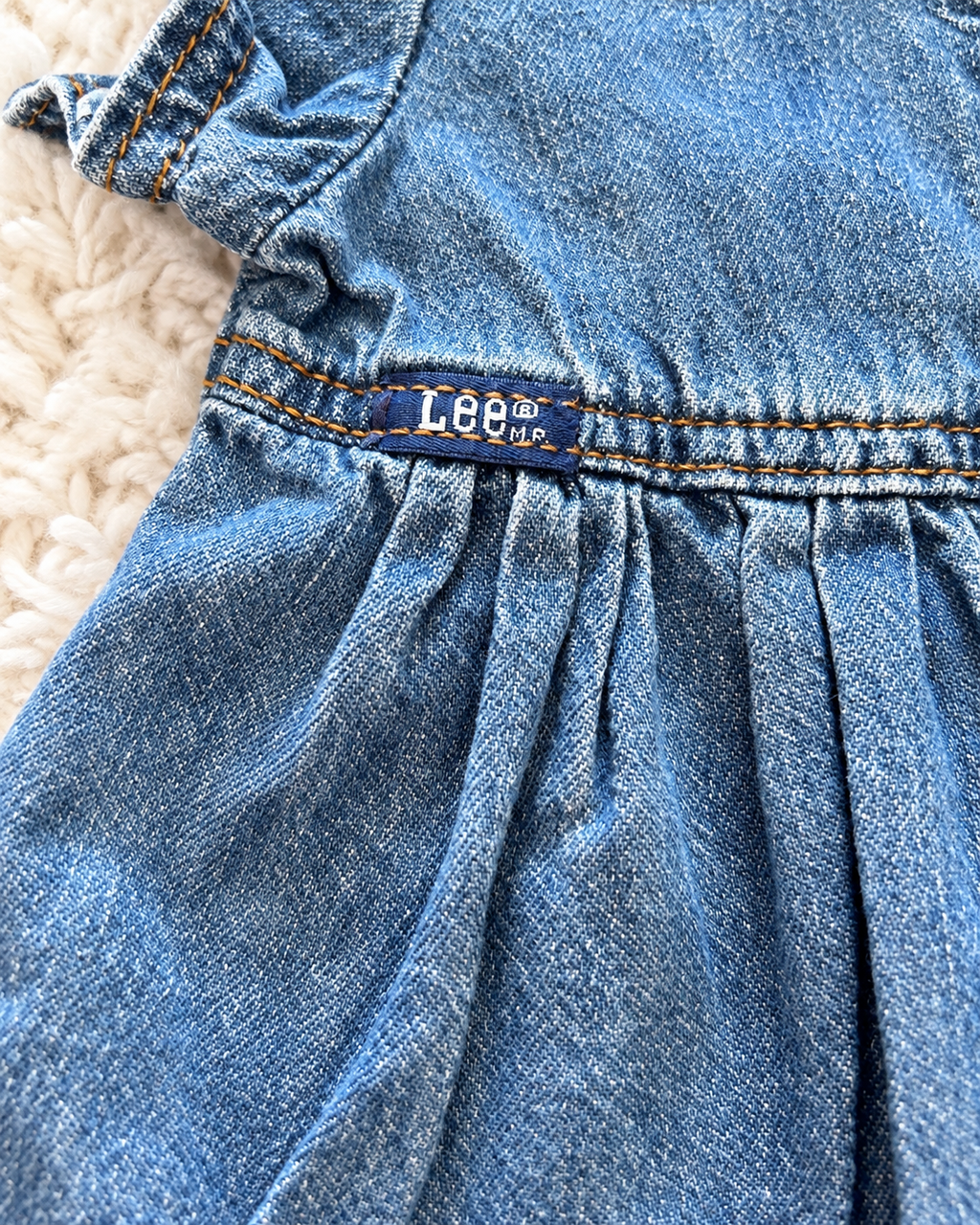 Close-up of Lee label on baby denim dress
