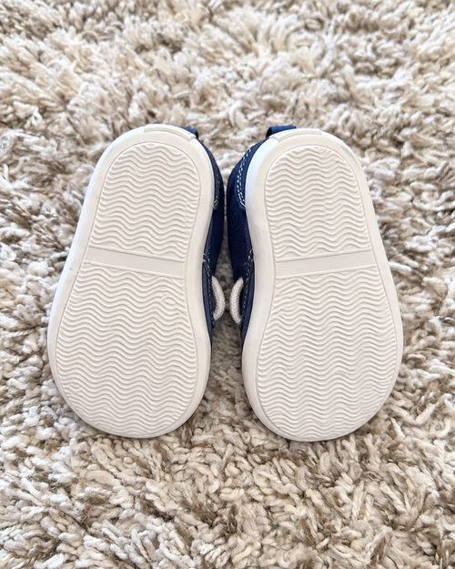 Navy and red baby sneakers sole view
