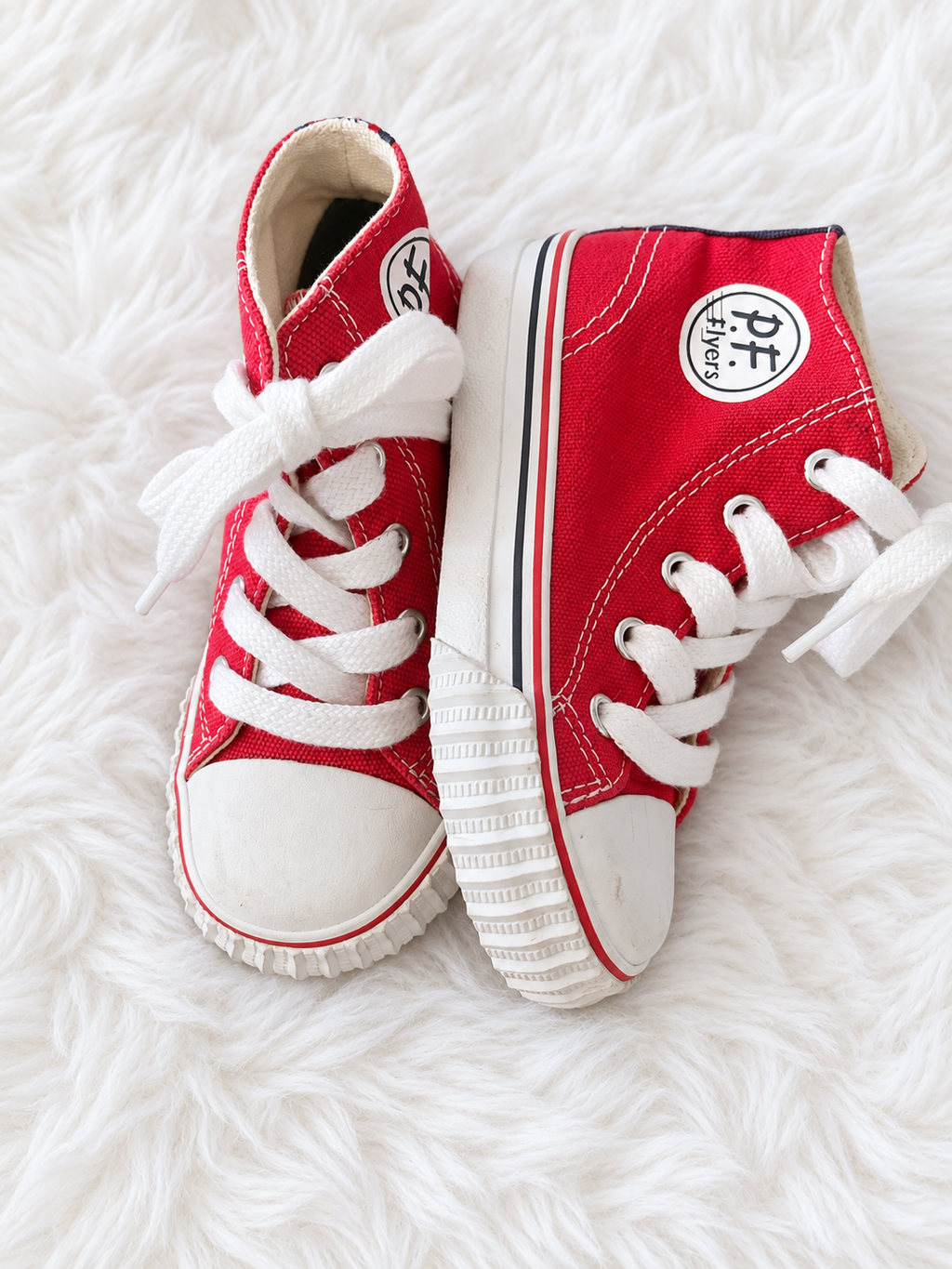 Side view of red P.F. Flyers toddler high tops