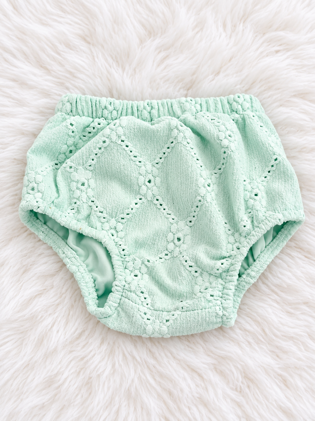 Matching mint eyelet bloomers on white rug