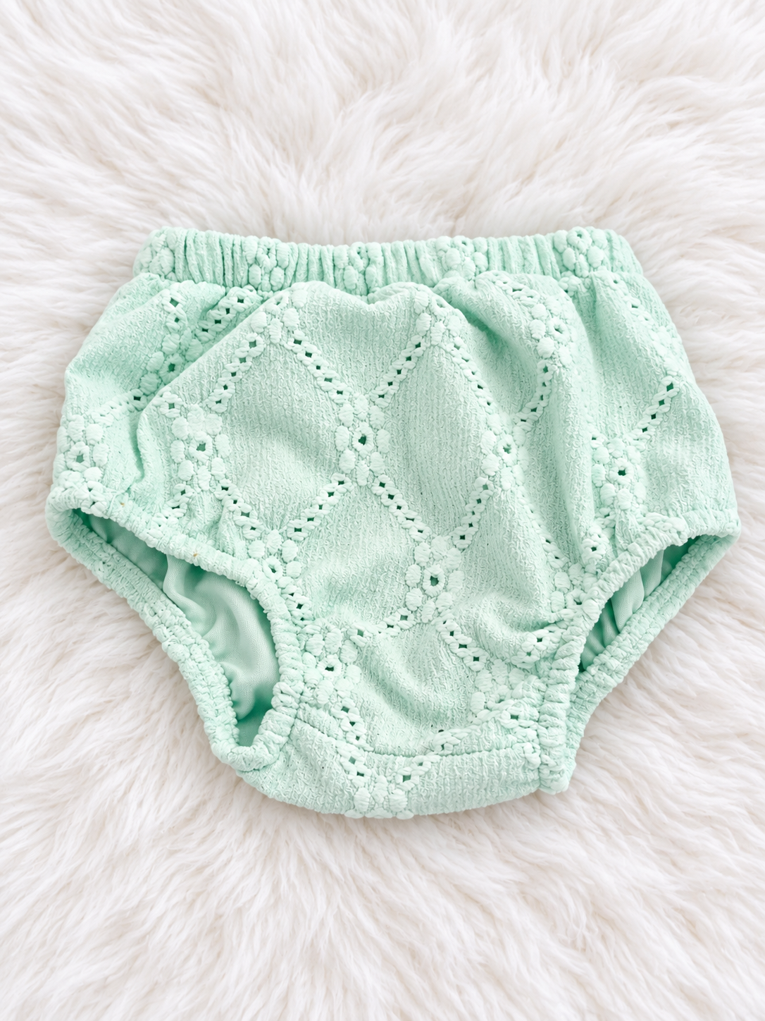 Matching mint eyelet bloomers on white rug