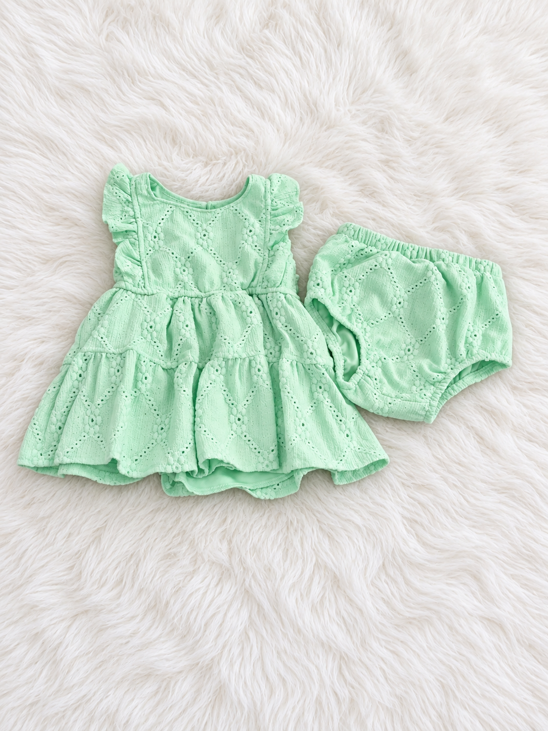 Mint eyelet dress and matching bloomers on white rug