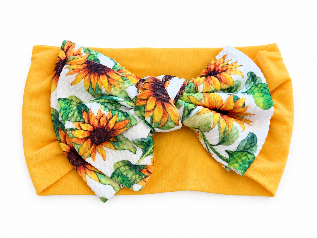Yellow sunflower bow baby headband on white background