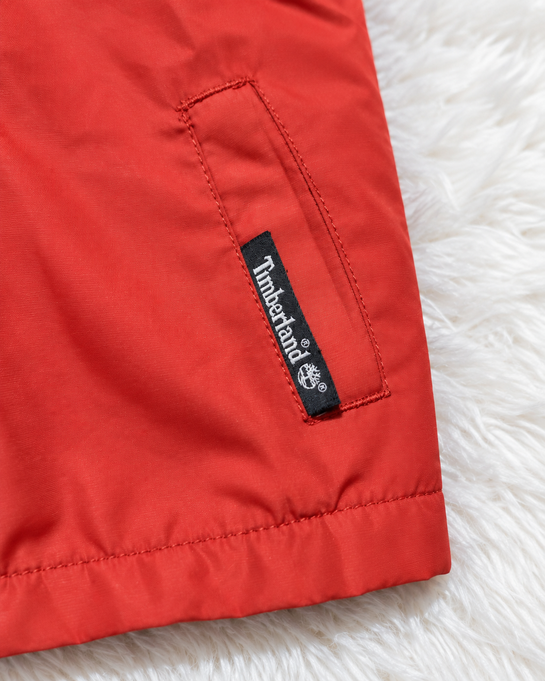 Timberland logo detail on red toddler jacket