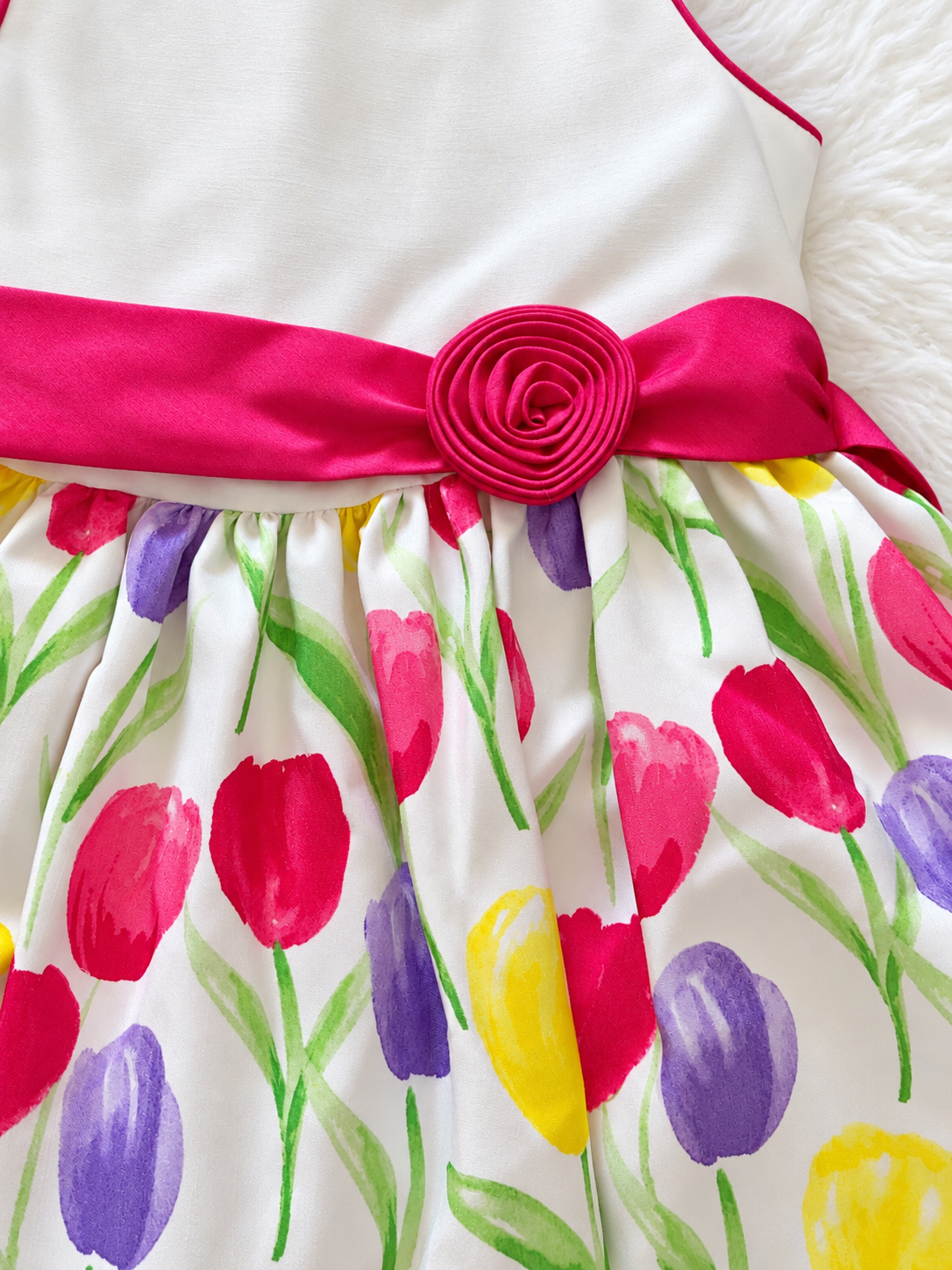 Pink sash and colorful tulip print detail